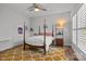 Bedroom featuring a four-poster bed, unique rug, and light filled shutters for a cozy retreat at 302 Ambleside Village Ln, Davidson, NC 28036