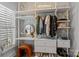 Walk-in closet with custom shelving, drawers, and desk area, providing organized storage and functionality at 302 Ambleside Village Ln, Davidson, NC 28036
