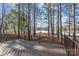 A spacious deck with a metal guardrail and a beautiful lake view surrounded by tall trees at 302 Ambleside Village Ln, Davidson, NC 28036