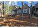 Beautiful exterior view of a stone-clad house with a porch and natural landscaping at 302 Ambleside Village Ln, Davidson, NC 28036