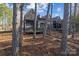 Beautiful exterior view of a stone-clad house with natural landscaping and a porch at 302 Ambleside Village Ln, Davidson, NC 28036