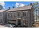 Beautiful two-story stone home with a glass garage door and pristine landscaping at 302 Ambleside Village Ln, Davidson, NC 28036
