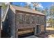 A lovely two-story stone home with a glass garage door and well-maintained landscaping at 302 Ambleside Village Ln, Davidson, NC 28036