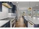 Contemporary kitchen with an island, navy cabinetry, stainless appliances, and an open view to the dining and living areas at 302 Ambleside Village Ln, Davidson, NC 28036
