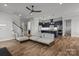 Open-concept living room flowing into a modern kitchen with navy blue cabinets and stylish pendant lighting at 302 Ambleside Village Ln, Davidson, NC 28036