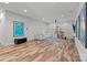 Spacious living room with light hardwood floors, recessed lighting, comfortable sofa, and stylish decor at 302 Ambleside Village Ln, Davidson, NC 28036