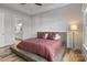 Modern bedroom showcasing a platform bed, tray ceiling, and natural light from the window at 302 Ambleside Village Ln, Davidson, NC 28036