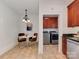 Bright kitchen nook with modern chandelier, stainless steel appliances, and access to laundry room at 324 Westwood Ave, Charlotte, NC 28203