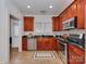 Well-equipped kitchen featuring wood cabinetry, stainless steel appliances, and granite countertops at 324 Westwood Ave, Charlotte, NC 28203