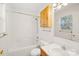 Well-lit bathroom with a tub, a shower, vanity, and a wooden storage cabinet at 341 Massey Deal Rd, Statesville, NC 28625