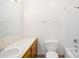 Bright bathroom featuring a white vanity, tile countertop, and shower-tub combination at 341 Massey Deal Rd, Statesville, NC 28625