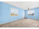 Comfortable bedroom with two windows, neutral carpeting, and fresh paint at 341 Massey Deal Rd, Statesville, NC 28625