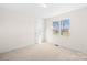 Bright bedroom featuring carpet flooring and a window with neighborhood views at 341 Massey Deal Rd, Statesville, NC 28625