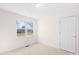 Empty bedroom with door, a window, and neutral carpeting at 341 Massey Deal Rd, Statesville, NC 28625