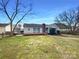 A charming single-story home with a spacious backyard and a wooden deck at 3632 Farm Lake Sw Dr, Concord, NC 28027