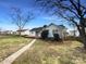 Backyard view of the house and deck, showcasing a brick pathway and mature trees at 3632 Farm Lake Sw Dr, Concord, NC 28027