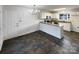 Eat-in kitchen featuring white cabinets and a stylish chandelier lighting at 3632 Farm Lake Sw Dr, Concord, NC 28027
