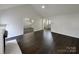 Open-concept living room with wood floors and a view of the kitchen at 3632 Farm Lake Sw Dr, Concord, NC 28027