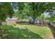 Expansive backyard with lush green grass, mature trees, and a wooden fence, perfect for outdoor activities and relaxation at 3714 Conway Ave, Charlotte, NC 28209