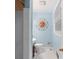 Small bathroom painted light blue with tiled shower, toilet and a decorative sun wall decoration at 3714 Conway Ave, Charlotte, NC 28209