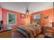 Cozy bedroom featuring hardwood floors, a colorful quilt, and plenty of natural light at 3714 Conway Ave, Charlotte, NC 28209