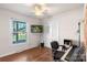 Bedroom with hardwood floors, a ceiling fan, a white closet and a mounted TV at 3714 Conway Ave, Charlotte, NC 28209