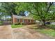 Charming brick home with lush green lawn and mature trees offering shade and curb appeal at 3714 Conway Ave, Charlotte, NC 28209
