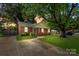 Charming brick home with lush green lawn and mature trees offering shade and curb appeal at 3714 Conway Ave, Charlotte, NC 28209