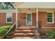 Close up of the front entrance, with brick steps, black railings, and space to welcome your guests at 3714 Conway Ave, Charlotte, NC 28209