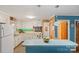 Well-lit kitchen features sleek white cabinets, green tile backsplash, and modern appliances at 3714 Conway Ave, Charlotte, NC 28209
