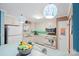 Bright kitchen features white cabinets, modern appliances, and hanging pendant lights at 3714 Conway Ave, Charlotte, NC 28209
