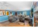 Spacious living room with hardwood floors, blue walls, fireplace, and large sectional couch at 3714 Conway Ave, Charlotte, NC 28209