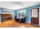 Living room with hardwood floors, fireplace and a table with seating at 3714 Conway Ave, Charlotte, NC 28209