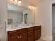 Bright bathroom featuring double sinks, white countertops, and a large mirror at 4856 Pepper Dr, Harrisburg, NC 28075