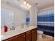 Bathroom featuring double vanity, large mirror, and a shower with blue striped curtain at 4856 Pepper Dr, Harrisburg, NC 28075