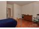 Bedroom with hardwood floors and a dresser and closet visible at 4856 Pepper Dr, Harrisburg, NC 28075