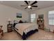 Carpeted bedroom with ceiling fan, two windows, and a queen bed at 4856 Pepper Dr, Harrisburg, NC 28075