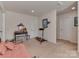 An adaptable room shows an exercise machine, twin bed, and multiple doors providing options for use as a bedroom at 4856 Pepper Dr, Harrisburg, NC 28075