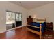 Bedroom with hardwood floors, a sliding glass door to the patio, and natural light at 4856 Pepper Dr, Harrisburg, NC 28075