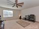 With a ceiling fan, large window, and carpet, this flex room offers space for entertainment or relaxation at 4856 Pepper Dr, Harrisburg, NC 28075