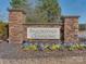 Stone entrance sign for Brookedale Commons with colorful flower beds, creating a welcoming entrance at 4856 Pepper Dr, Harrisburg, NC 28075
