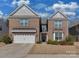 A beautiful two-story brick house, featuring a two-car garage and manicured front lawn for a welcoming entrance at 4856 Pepper Dr, Harrisburg, NC 28075