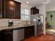 Well-lit kitchen with stainless steel refrigerator and appliances and dark wood cabinetry at 4856 Pepper Dr, Harrisburg, NC 28075