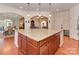 A granite-topped kitchen island is displayed with cabinets and recessed lighting, opening to the breakfast and living areas at 4856 Pepper Dr, Harrisburg, NC 28075