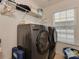 A laundry room featuring washer, dryer, storage shelves and a window for natural light at 4856 Pepper Dr, Harrisburg, NC 28075