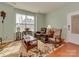 Inviting living room with large window, hardwood floors, and a comfortable seating area with a rug at 4856 Pepper Dr, Harrisburg, NC 28075
