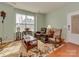 Inviting living room featuring natural light, hardwood floors, and comfortable seating arrangement at 4856 Pepper Dr, Harrisburg, NC 28075