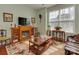 Light-filled living room with hardwood floors, a fireplace, and large windows at 4856 Pepper Dr, Harrisburg, NC 28075