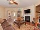 Cozy living room with hardwood floors, fireplace, and open layout, seamlessly connecting to other living spaces at 4856 Pepper Dr, Harrisburg, NC 28075