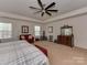 Spacious primary bedroom with a seating area, a queen bed, and plush carpet at 4856 Pepper Dr, Harrisburg, NC 28075